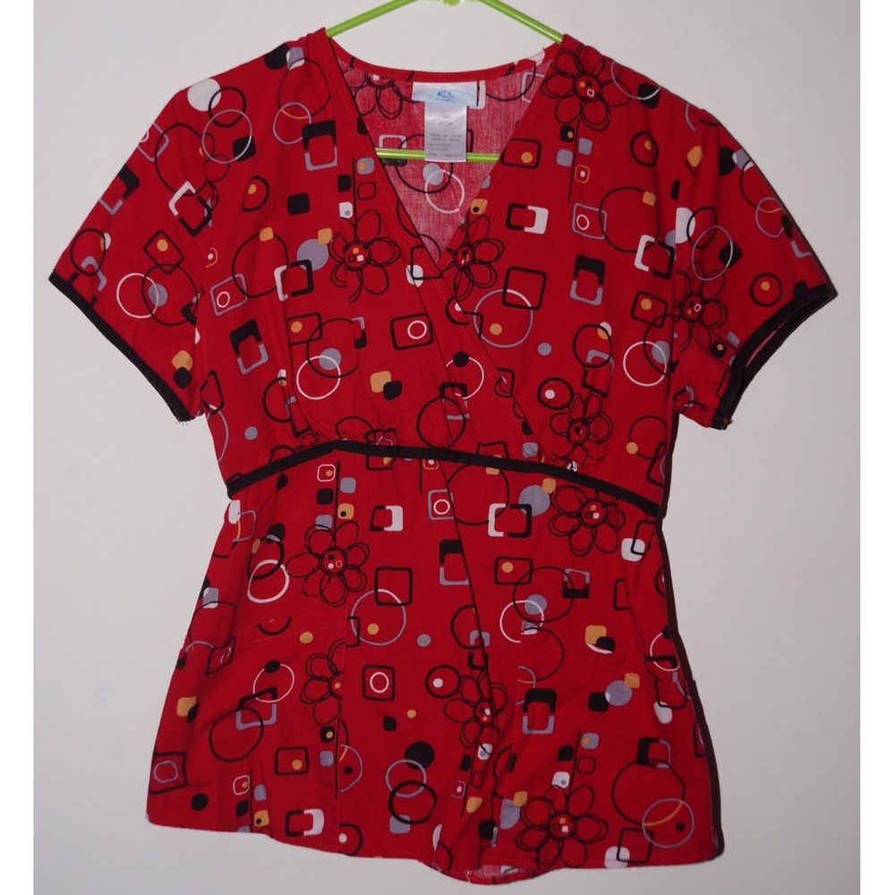 Red geometric floral pattern scrub top